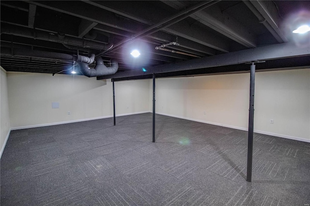 basement featuring dark colored carpet