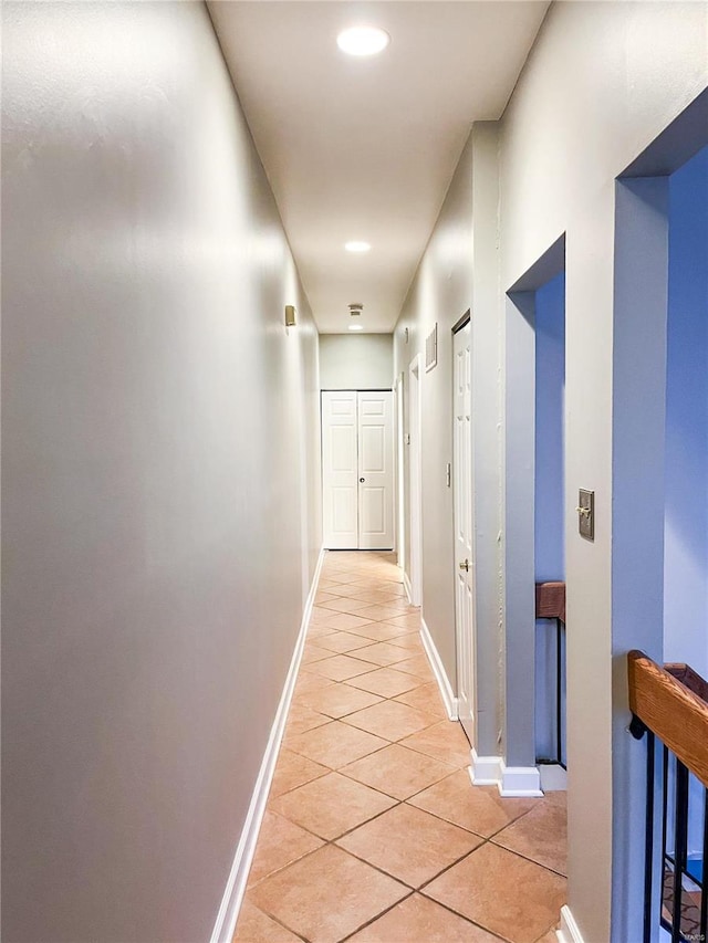 hall with light tile patterned floors