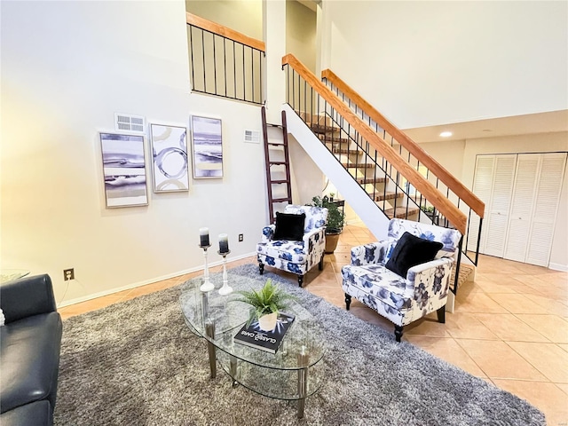 tiled living room with a towering ceiling