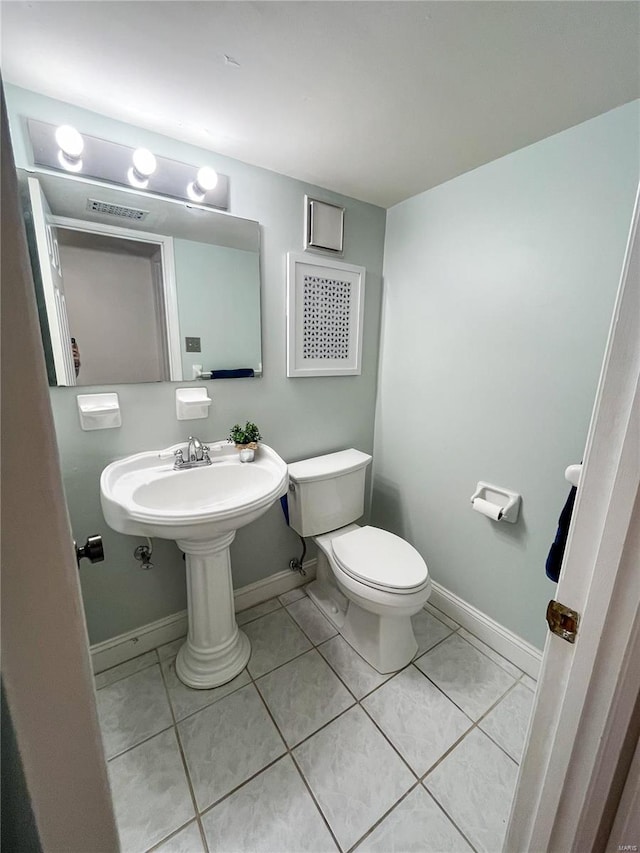 bathroom with tile patterned flooring and toilet