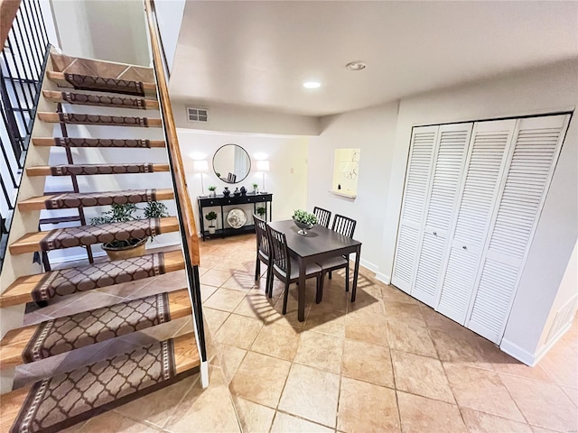 dining space featuring light tile patterned flooring