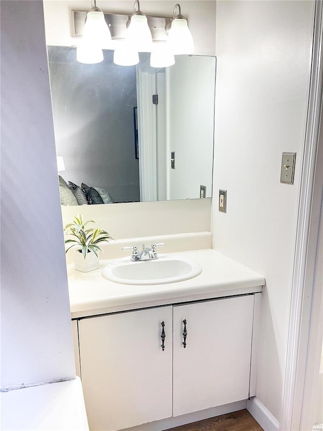 bathroom with vanity and hardwood / wood-style floors