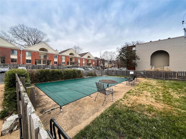 view of swimming pool featuring a patio and a lawn