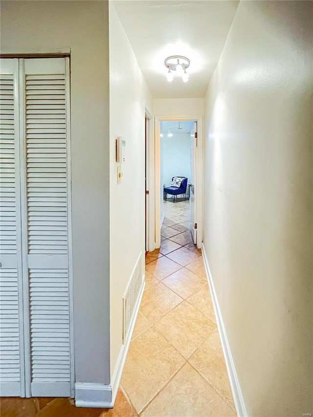 corridor featuring light tile patterned flooring