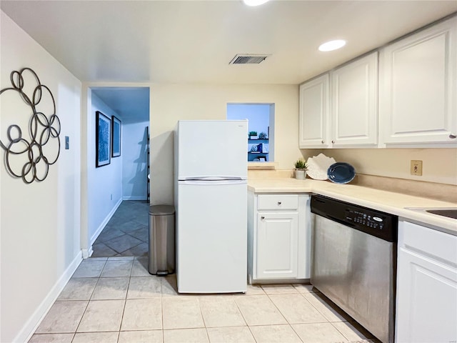 kitchen featuring light tile patterned flooring, dishwasher, white fridge, and white cabinets