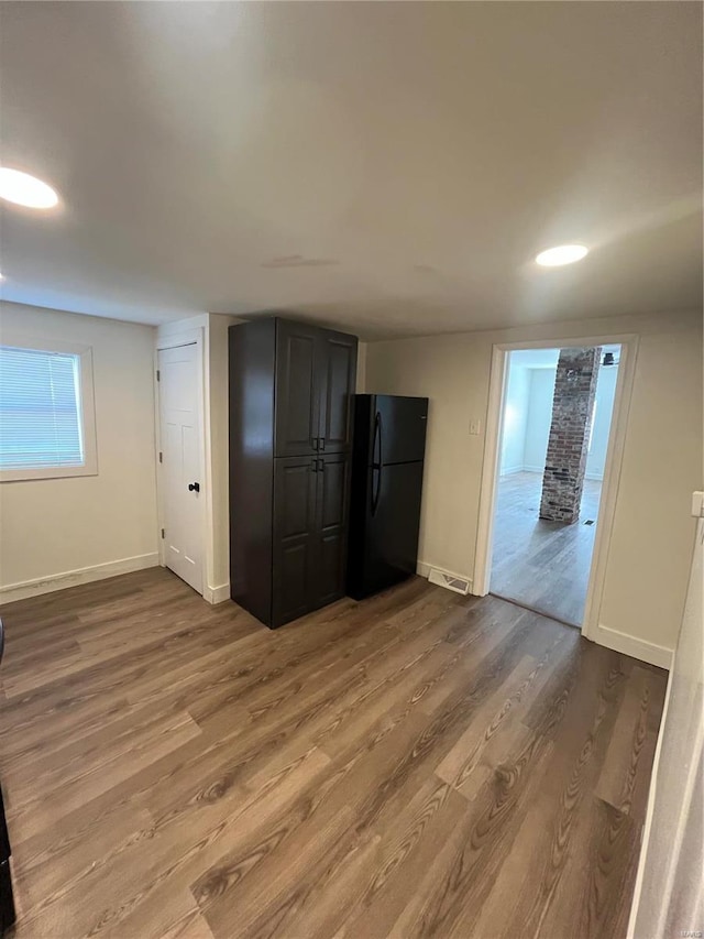 unfurnished room with hardwood / wood-style floors