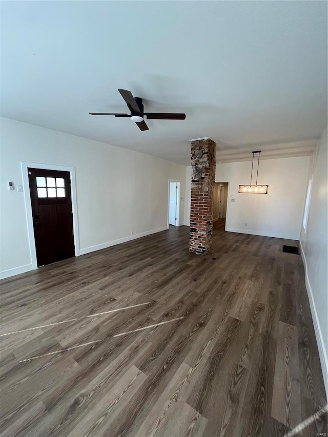 unfurnished living room with brick wall, ceiling fan, and dark hardwood / wood-style floors