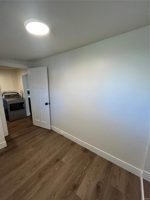 unfurnished room with dark hardwood / wood-style flooring and washer / clothes dryer