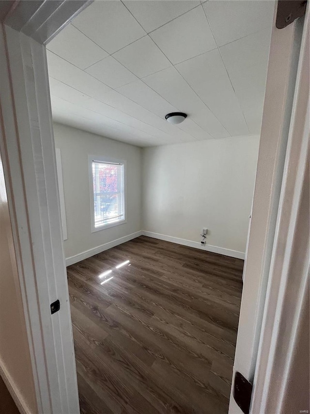 empty room with dark wood-type flooring