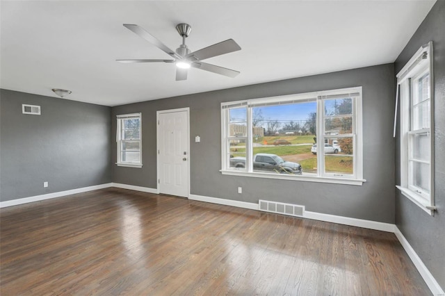 unfurnished room featuring hardwood / wood-style flooring, a healthy amount of sunlight, and ceiling fan