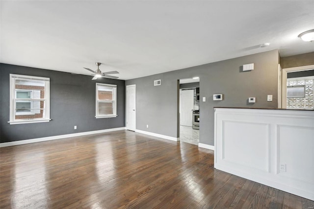 unfurnished living room featuring ceiling fan, hardwood / wood-style flooring, and plenty of natural light