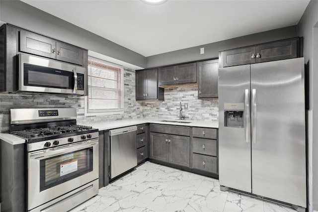 kitchen featuring appliances with stainless steel finishes, dark brown cabinetry, sink, tasteful backsplash, and light tile patterned floors