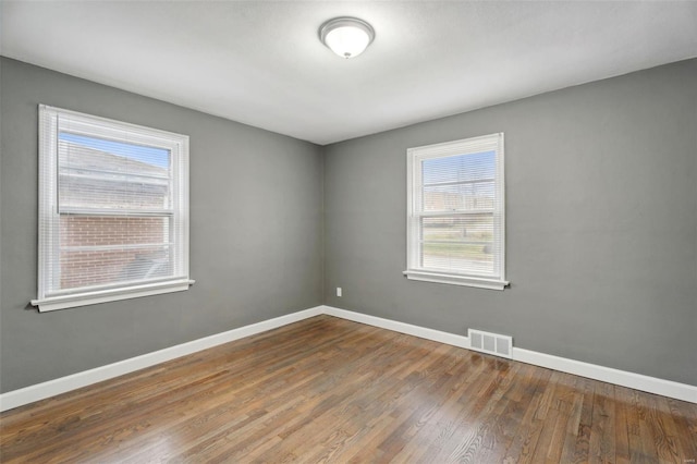 unfurnished room with wood-type flooring