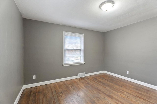 empty room featuring hardwood / wood-style flooring