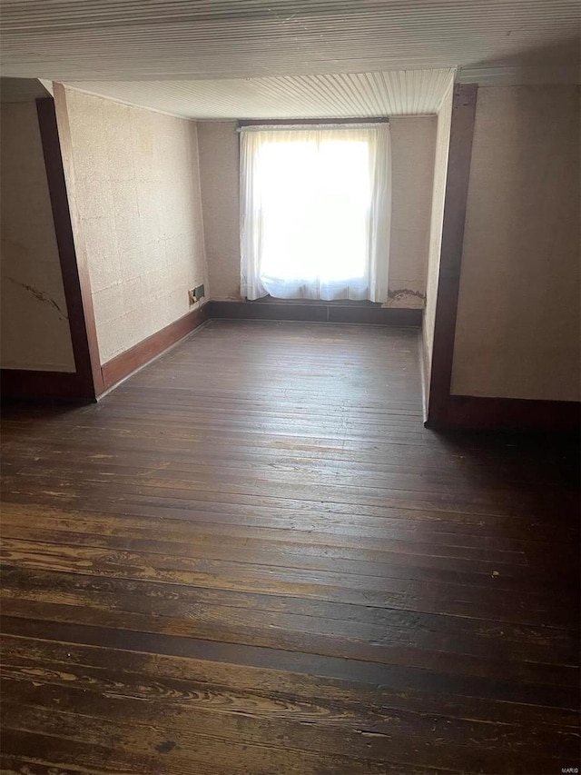 unfurnished room featuring dark hardwood / wood-style flooring