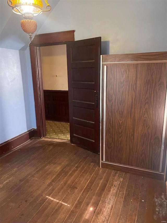 empty room with dark hardwood / wood-style flooring