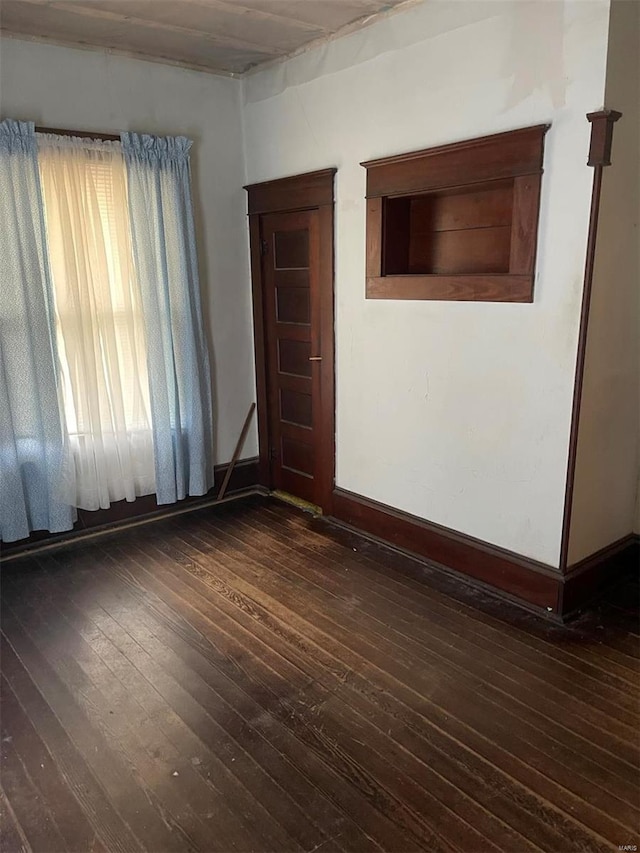 spare room featuring dark hardwood / wood-style floors