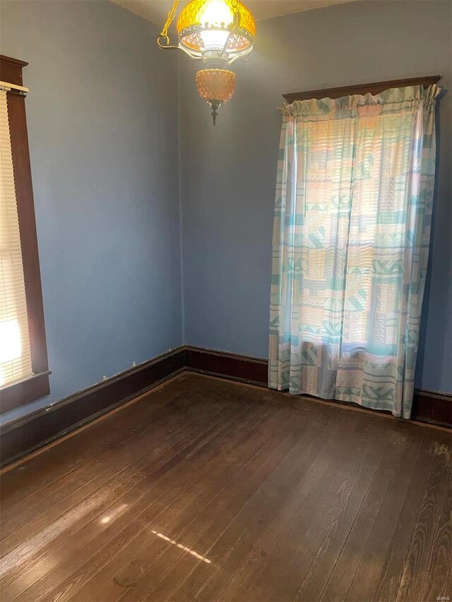 unfurnished room with wood-type flooring