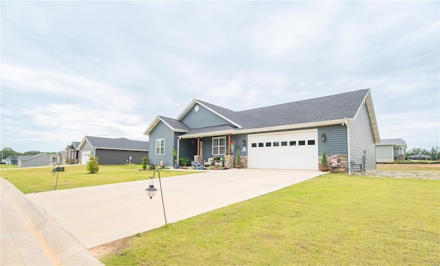 view of front of property with a garage, a front yard, stone siding, and driveway