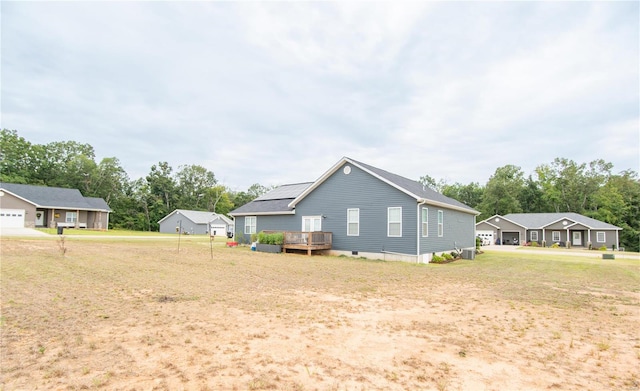 view of yard with a wooden deck and a garage