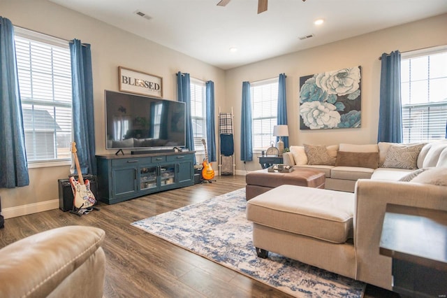 living room featuring ceiling fan, dark wood-style flooring, visible vents, and baseboards