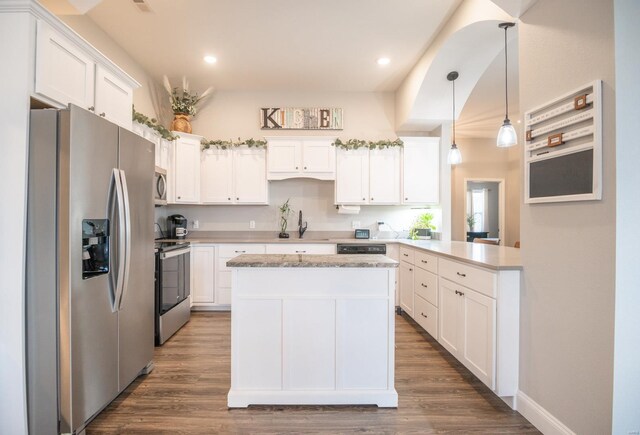 kitchen featuring pendant lighting, stainless steel appliances, dark hardwood / wood-style floors, and white cabinetry