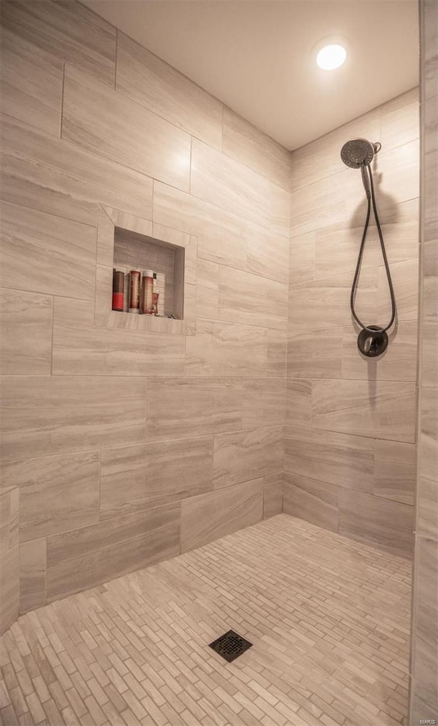 bathroom with a tile shower