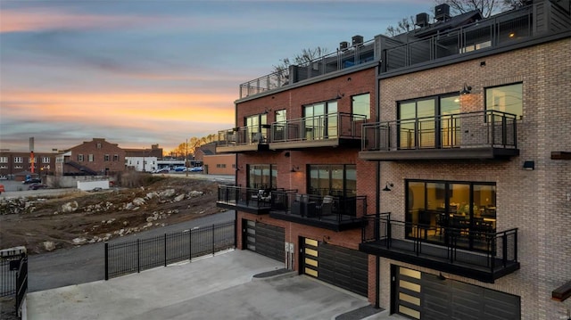 exterior space featuring a garage and a balcony