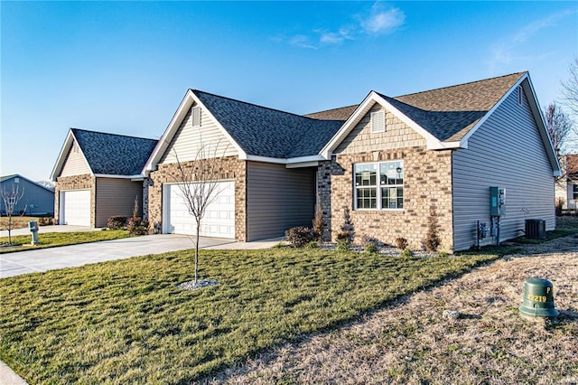 view of front of property featuring a garage, central AC, and a front yard