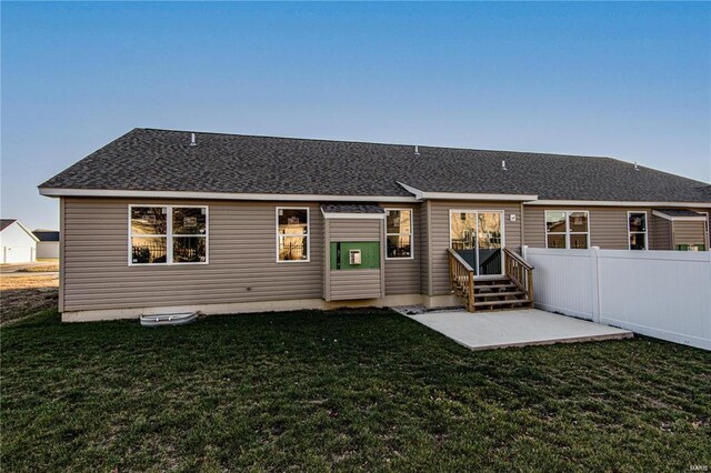 rear view of house featuring a patio and a yard