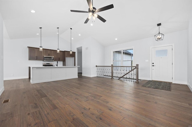 unfurnished living room with dark wood-type flooring, ceiling fan, and lofted ceiling