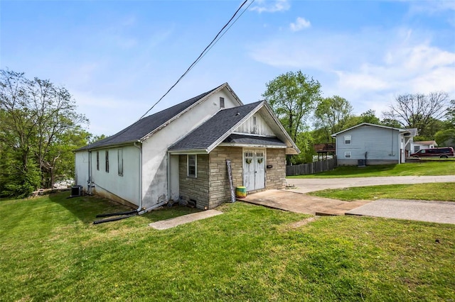 view of front of home featuring a front yard and central AC unit