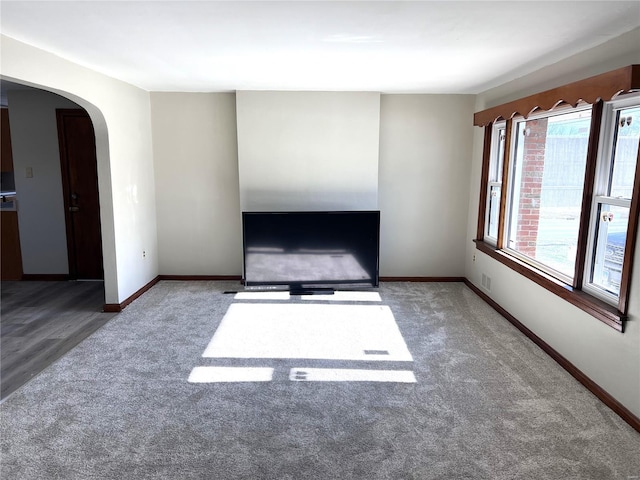 unfurnished room featuring dark colored carpet