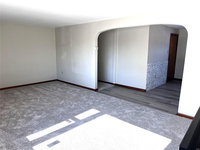 unfurnished room featuring dark carpet