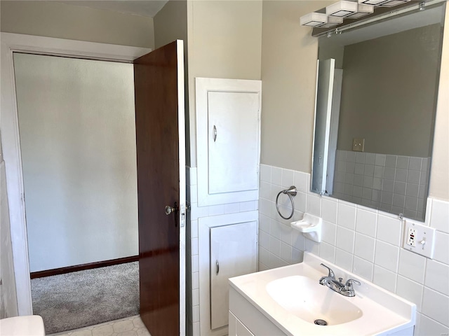 bathroom featuring tile flooring, tile walls, tasteful backsplash, and large vanity