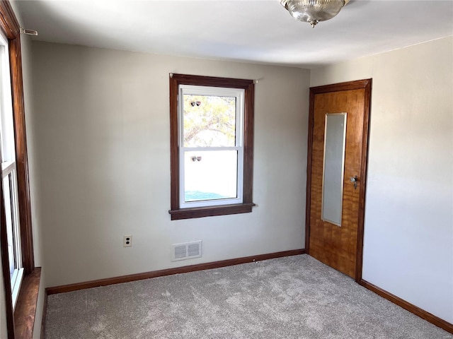 spare room featuring dark carpet