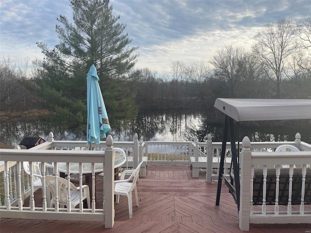 wooden terrace featuring a water view