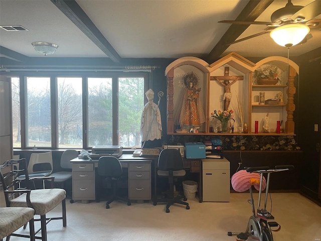 office featuring light colored carpet, ceiling fan, and beamed ceiling