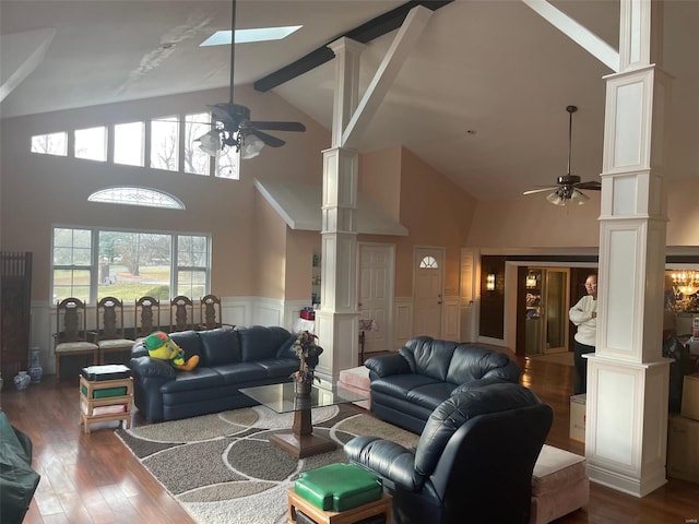 living room with high vaulted ceiling, ceiling fan with notable chandelier, and ornate columns