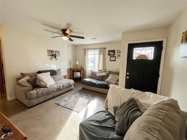 living room featuring light tile floors and ceiling fan