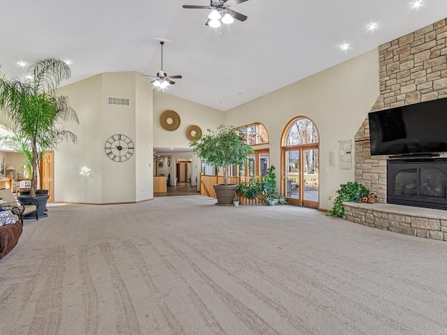 living room with carpet, high vaulted ceiling, a fireplace, and ceiling fan