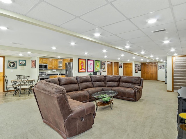 carpeted living room featuring a paneled ceiling