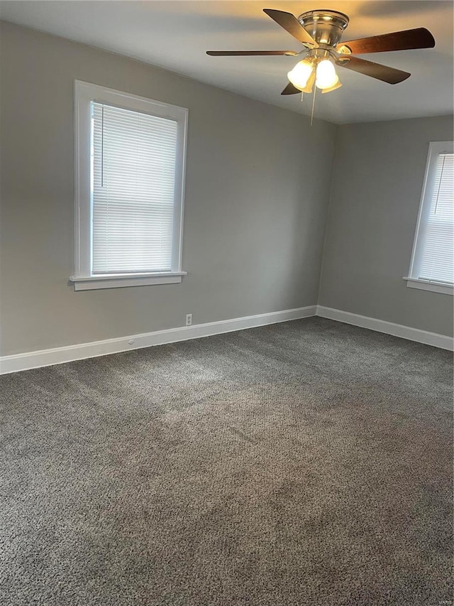 carpeted spare room with a healthy amount of sunlight and ceiling fan