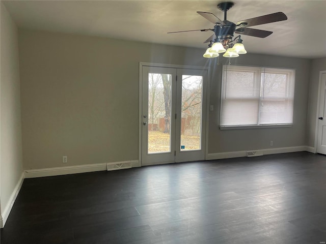 unfurnished room with dark hardwood / wood-style flooring and ceiling fan