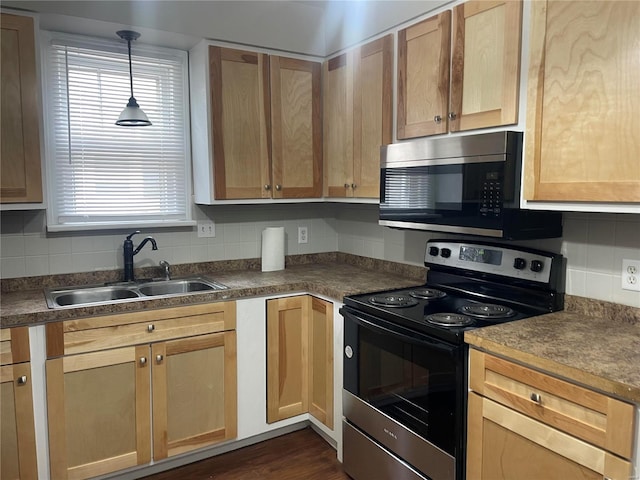 kitchen with dark hardwood / wood-style floors, hanging light fixtures, appliances with stainless steel finishes, decorative backsplash, and sink