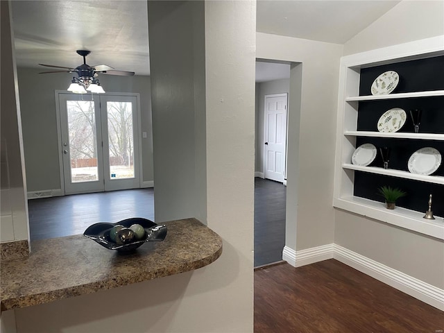 interior space with dark hardwood / wood-style floors, ceiling fan, and built in shelves