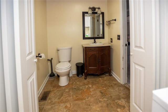 bathroom with toilet, tile floors, and large vanity