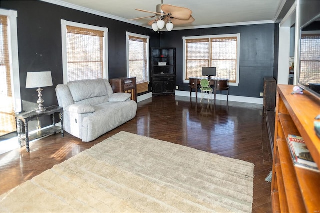 living room featuring ceiling fan, ornamental molding, and dark wood-type flooring