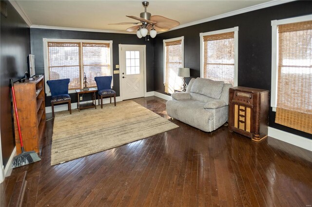 living room with crown molding, dark hardwood / wood-style flooring, and ceiling fan