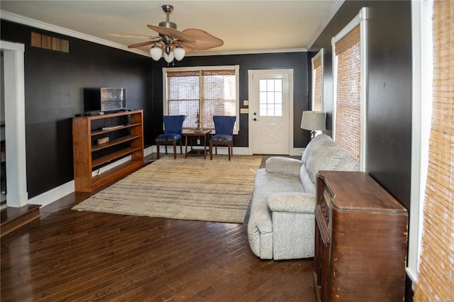 living room featuring ornamental molding, ceiling fan, and dark hardwood / wood-style flooring